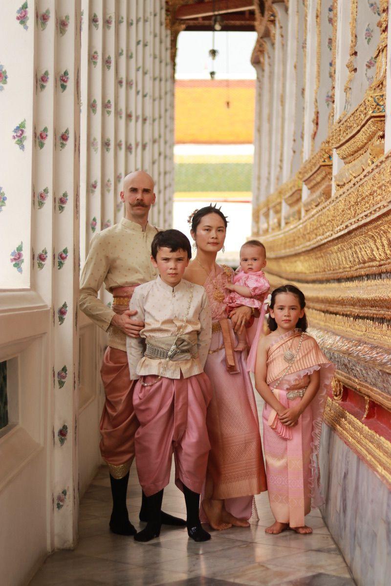 The founding Patrol Family — two parents and their kids in traditional Thai dress.