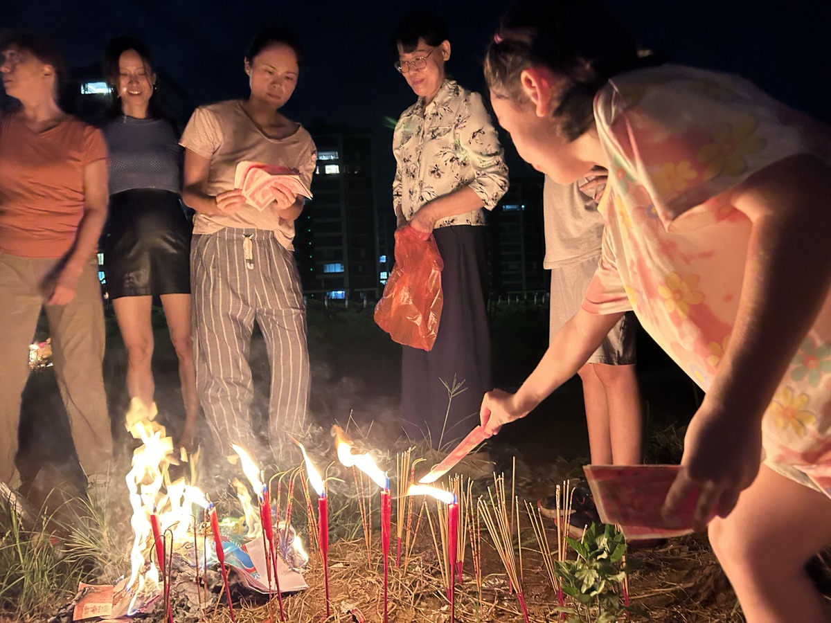 Speaking to ancestors by name and performing a traditional Chinese ceremony.